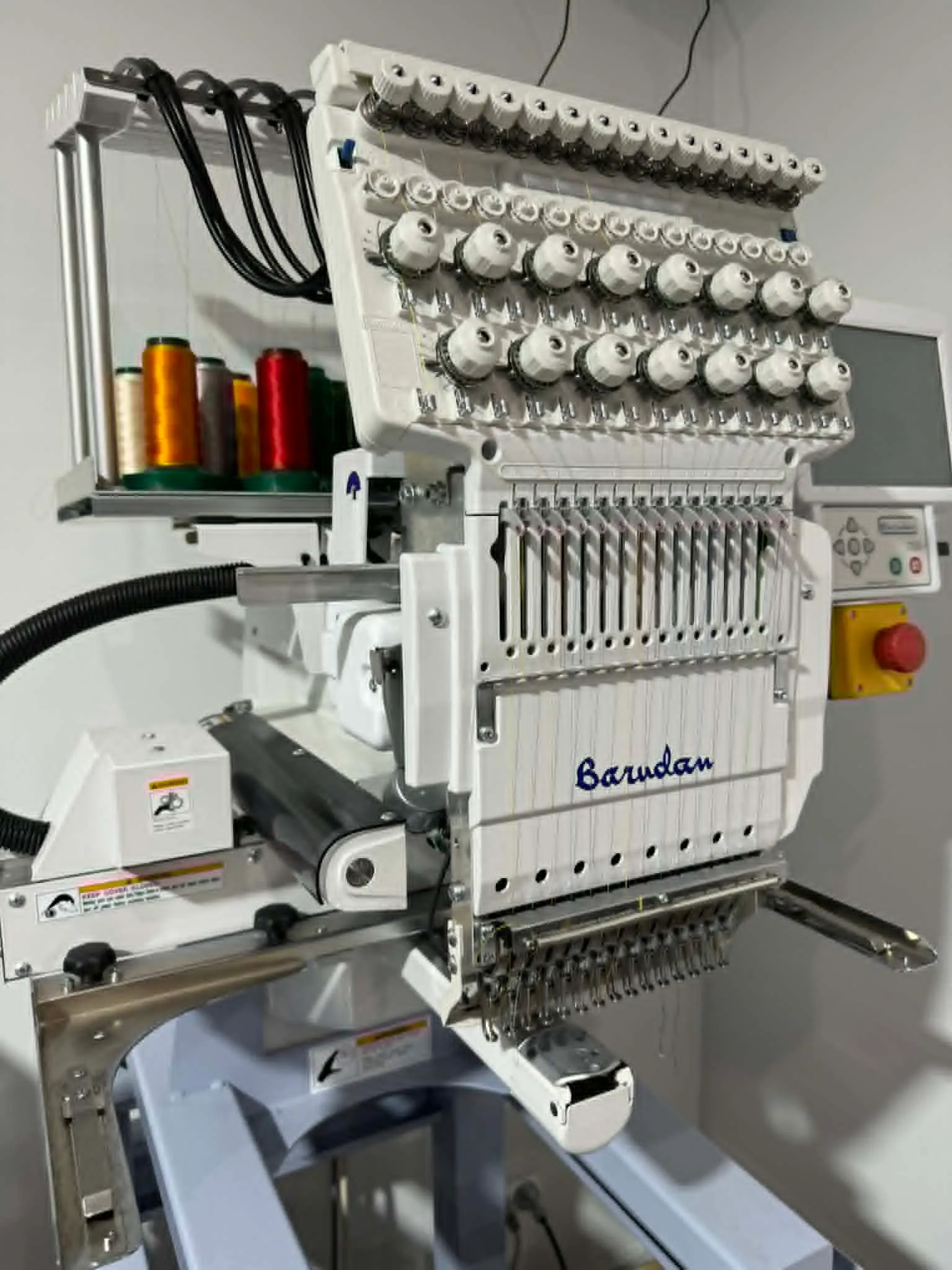 Image: Embroidery in action, showing a logo being stitched onto a polo shirt using a Barudan machine.
